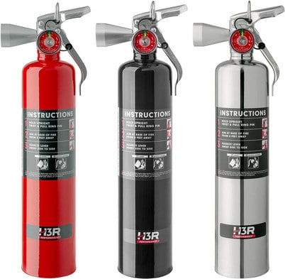 Three fire extinguishers in red, black, and silver stand next to each other in a product shot to show the different colors of H3R available.