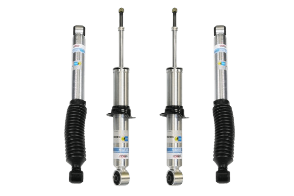 Four components of black and silver shocks stand upright on a white background.
